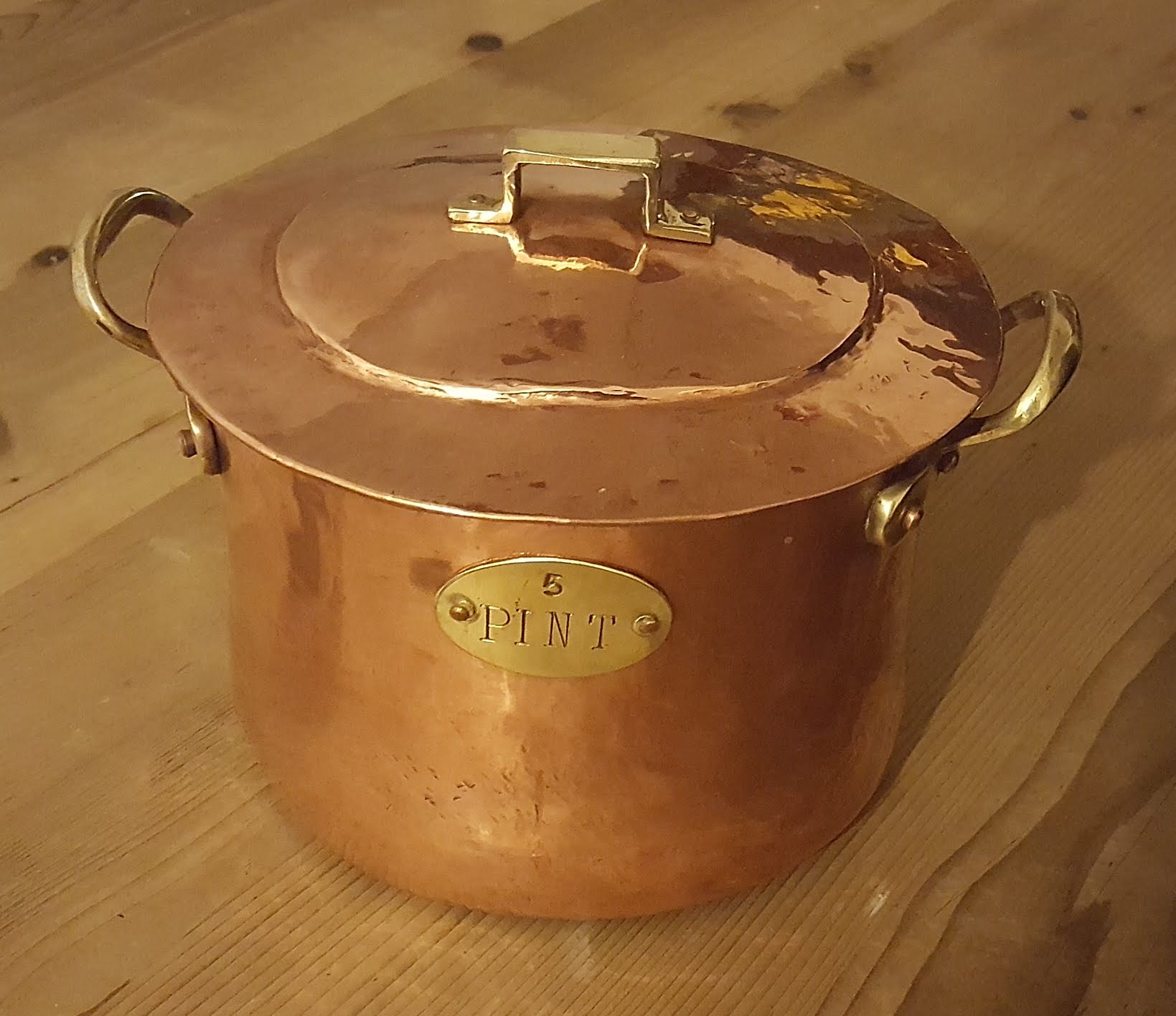 Copper pot with brass handles